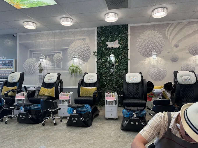 Row of pedicure massage chairs at MY Nails & Spa in Post Falls, Idaho with decorative greenery wall