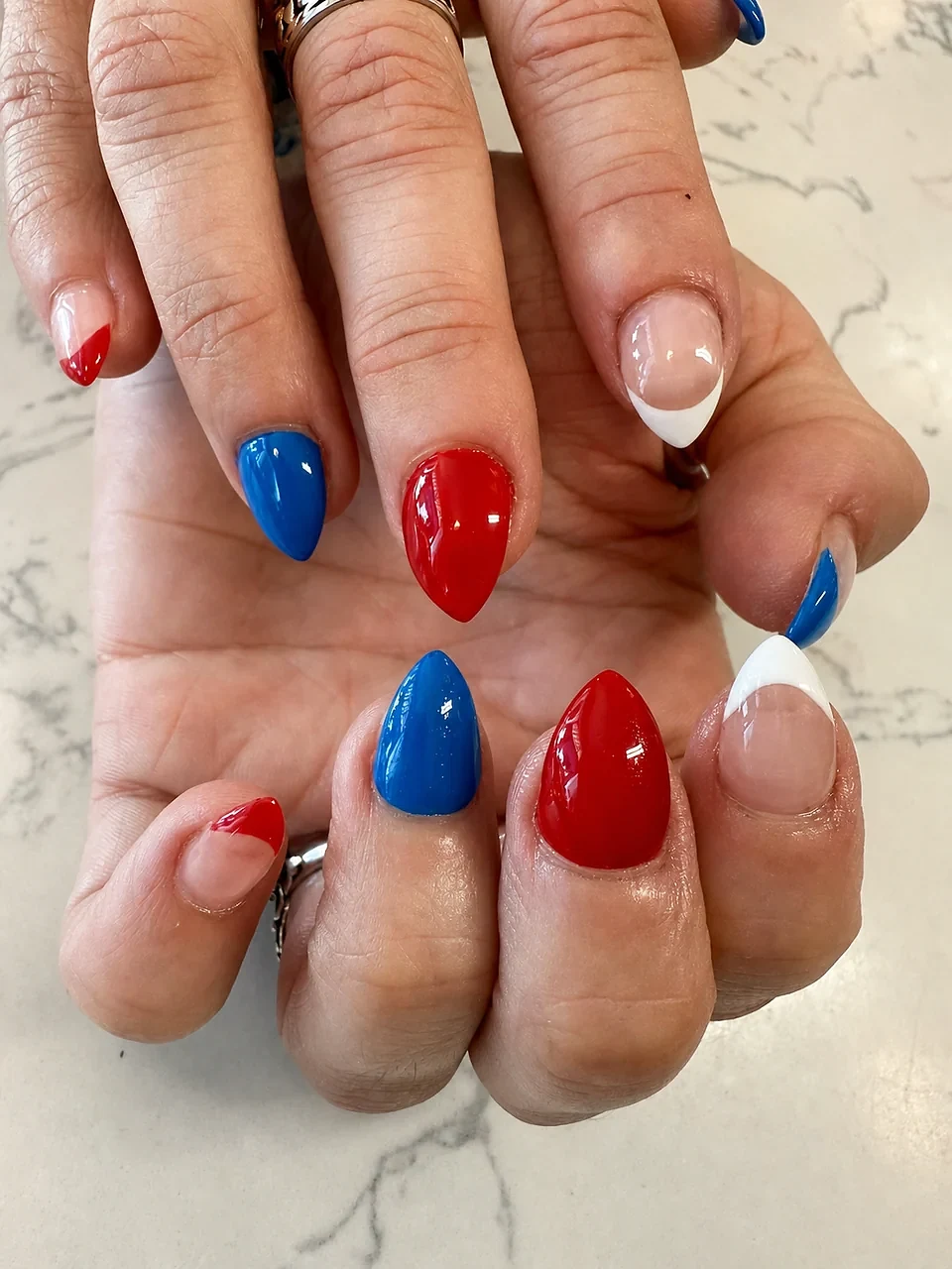 Red, white, and blue almond nails with french tip accents